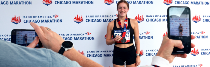 Participant posing with the 2025 Bank of America Chicago Marathon medal